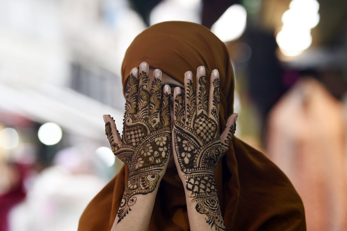 Woman shows henna-decorated hands ahead of Eid al-Adha in Srinagar