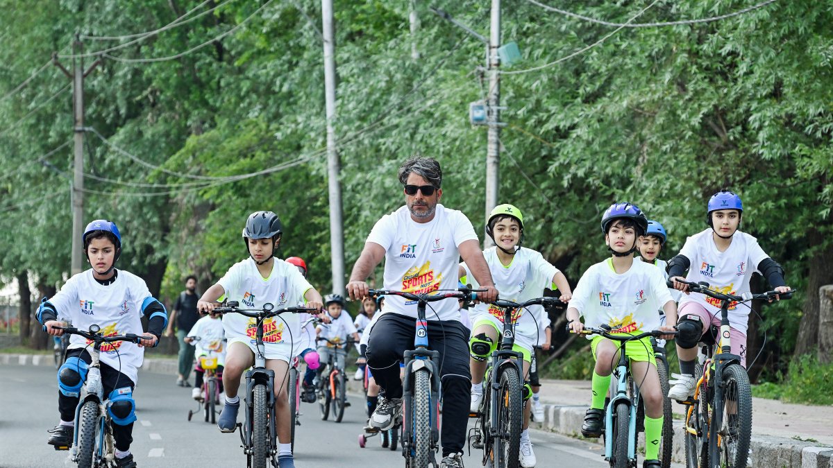 Children and man cycle in Srinagar on World Bicycle Day