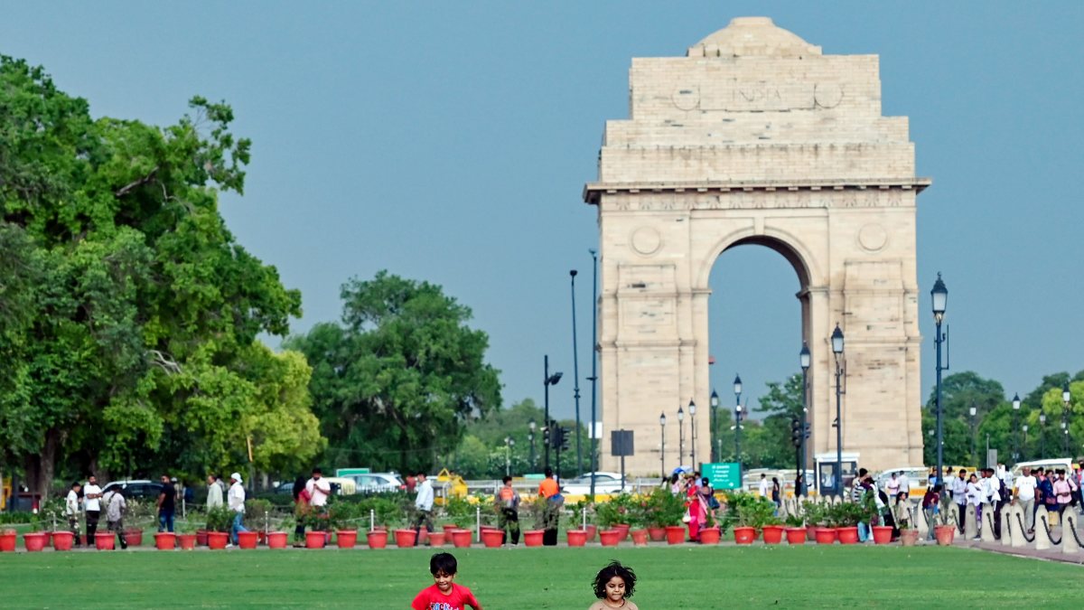 Children play at India Gate lawn after rain in Delhi