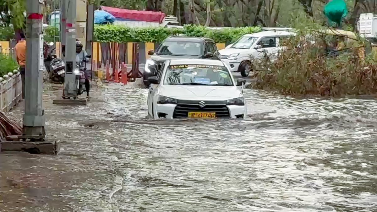 Vehicles move through waterlogged Noida after rain