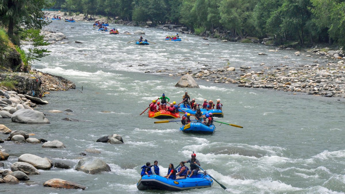 Tourists enjoy river rafting in Beas River at Manali