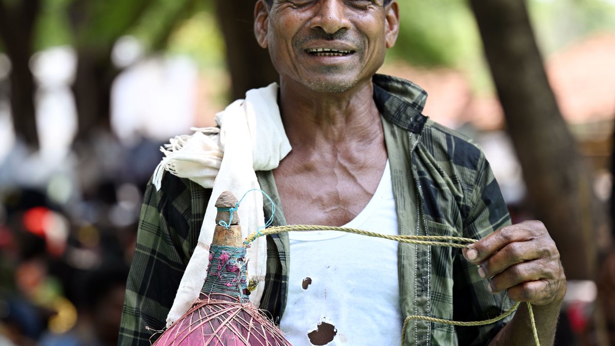 Tribal man carries fridge-like gourd to keep water cool