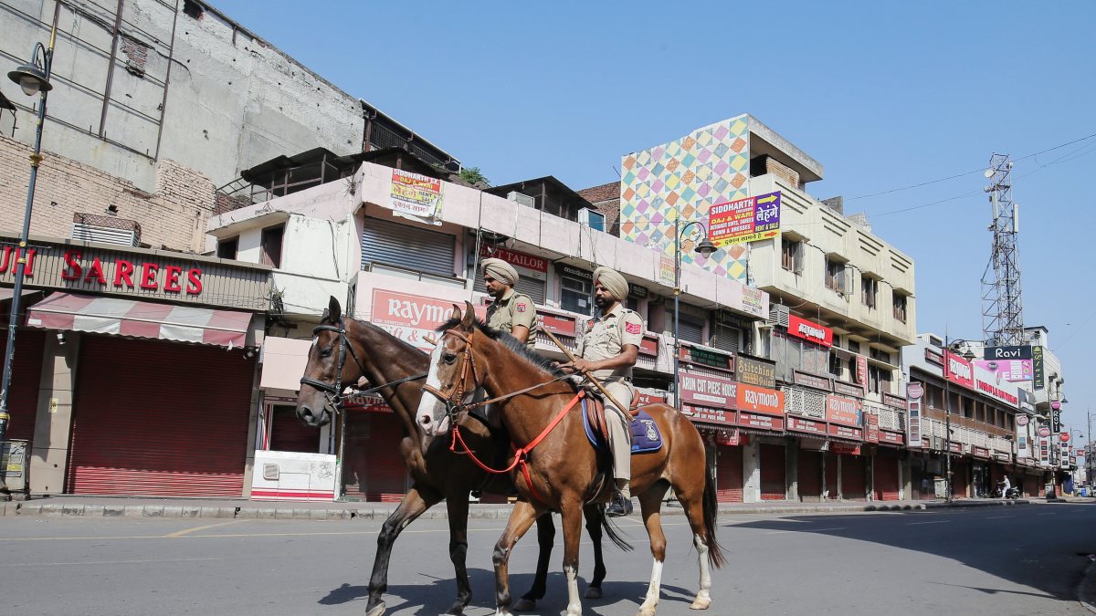 Policemen on horseback patrol in a deserted market during a one-day strike call…