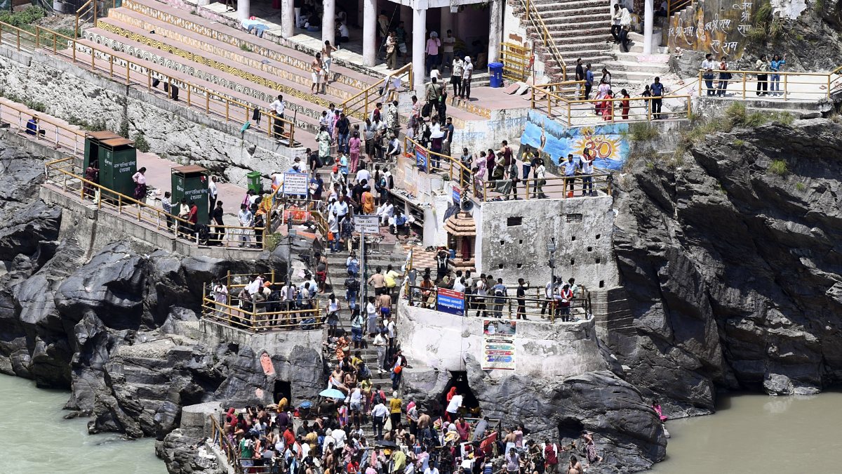 Devotees take a dip at the Sangam of Alaknanda and Bhagirathi rivers at…