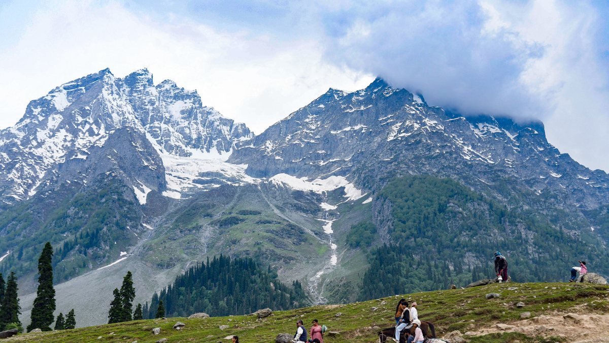 Tourists enjoy a horse ride at the tourist spot Sonmarg, in Ganderbal on Monday.