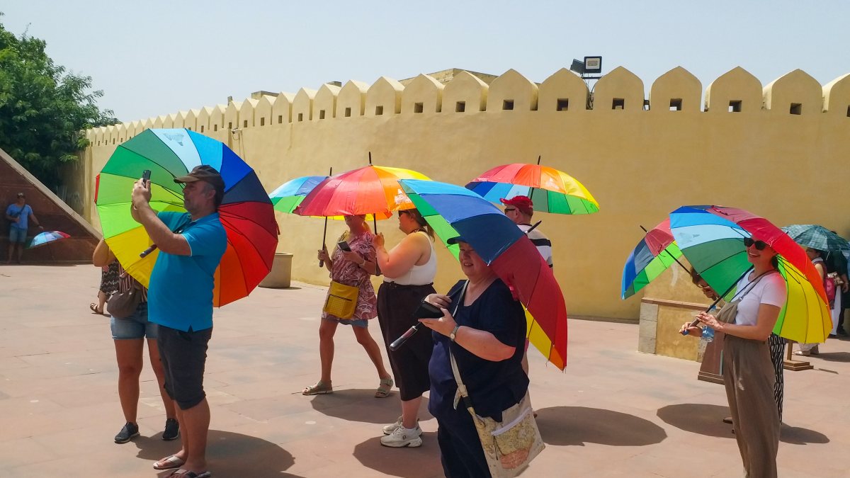Tourists use colourful umbrellas to beat Jaipur heat