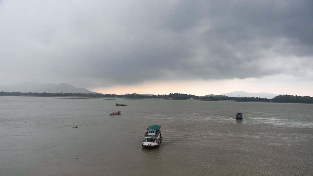 Passenger ferry crosses Brahmaputra under dark clouds in Guwahati
