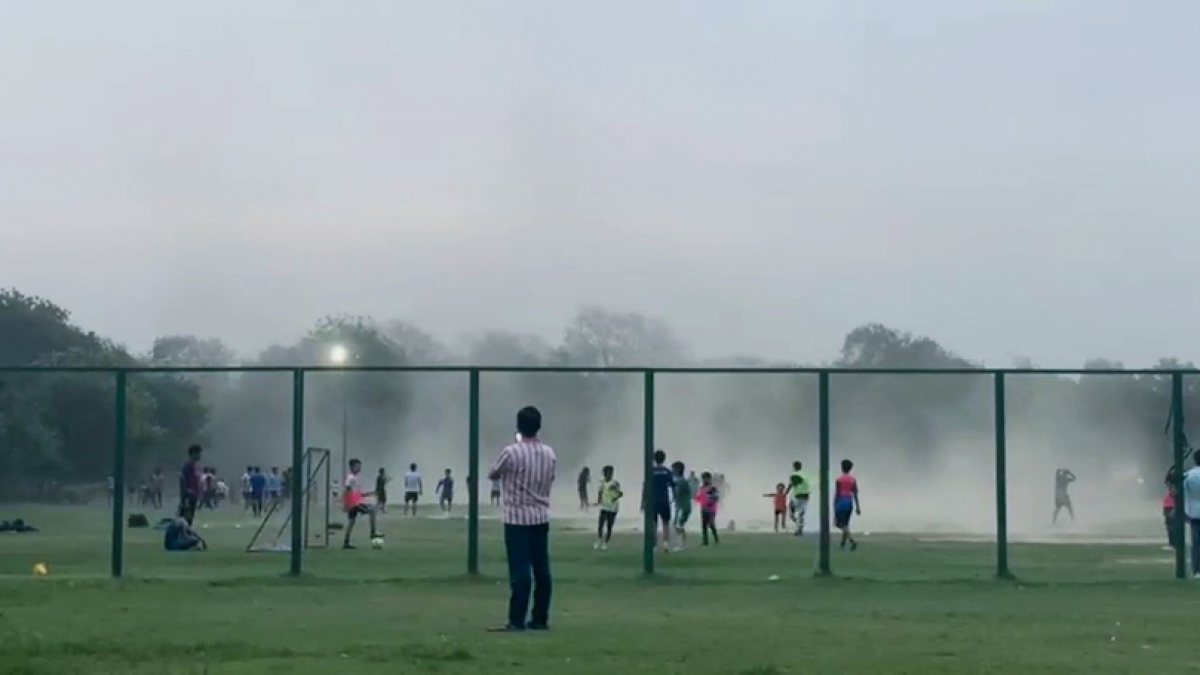 Children play in park as rain lashes Delhi