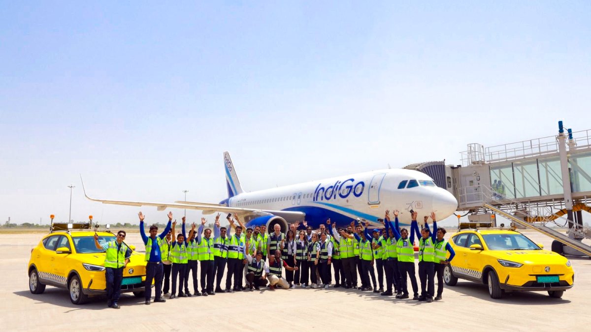 Airport personnel pose during IndiGo trial at Noida airport