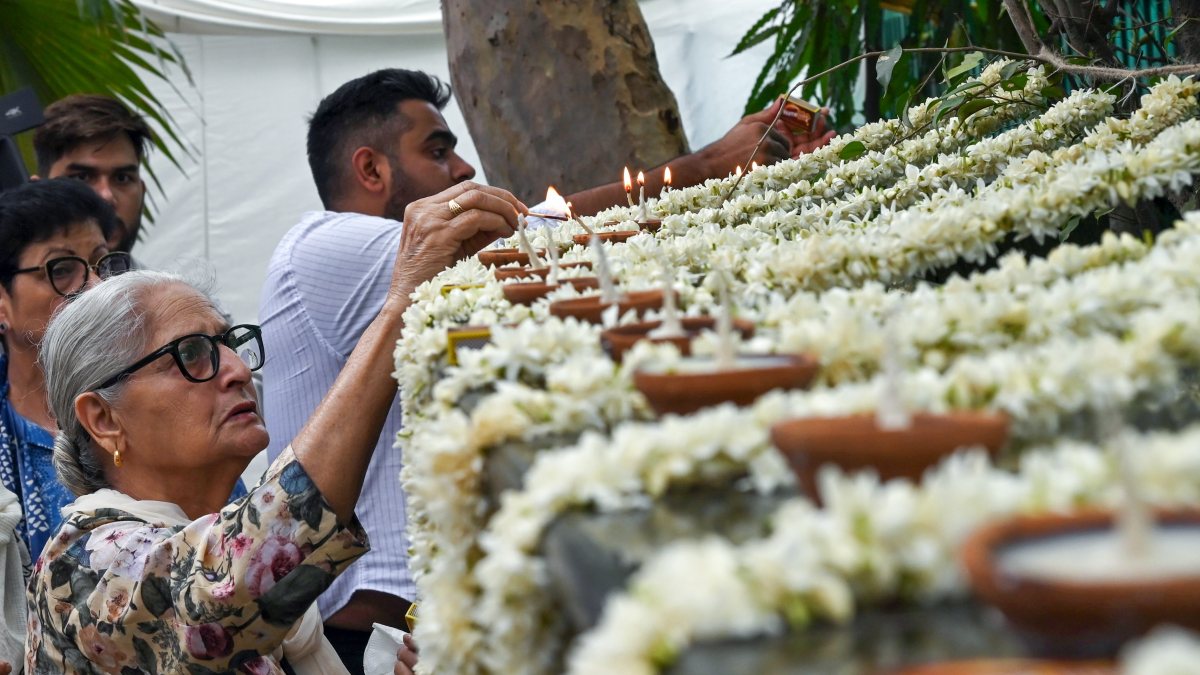 Members of the Association of the Victims of Uphaar Tragedy light lamps as…