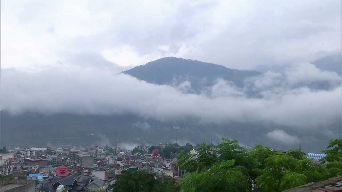 A view of the cloud-covered mountains after a significant drop in the…