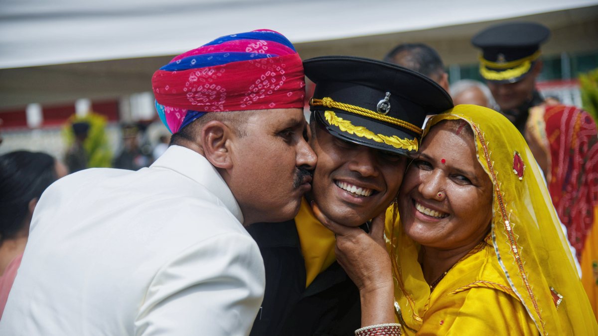 Newly inducted officer cadet with parents at IMA passing-out parade
