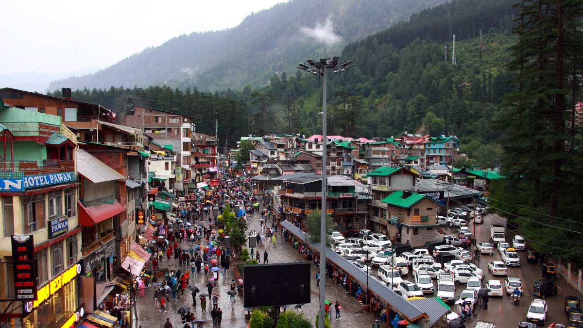 Tourists enjoy rainfall on Manali's Mall Road