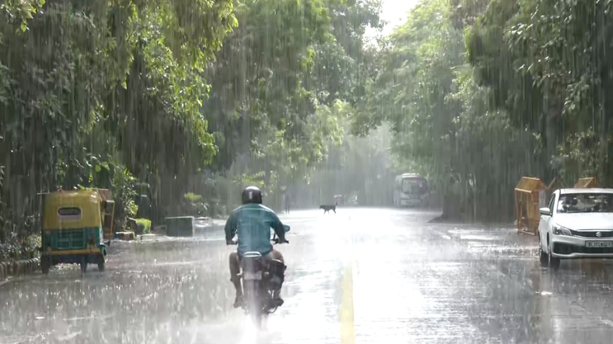 Commuters navigate waterlogged road during Delhi rain