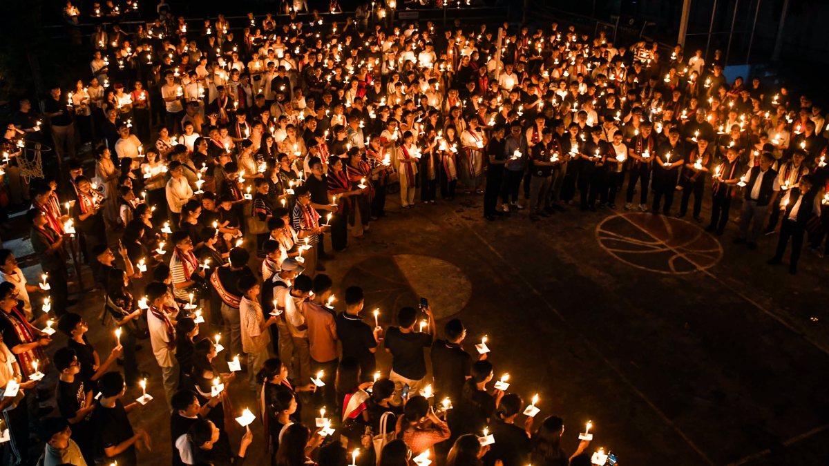Members of the Naga community participate in a candlelight vigil to pay tribute…