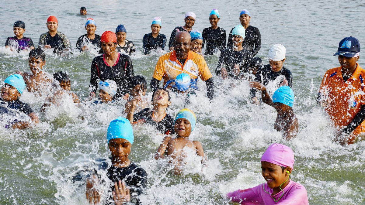 Children cool off in Yamuna River on hot summer day