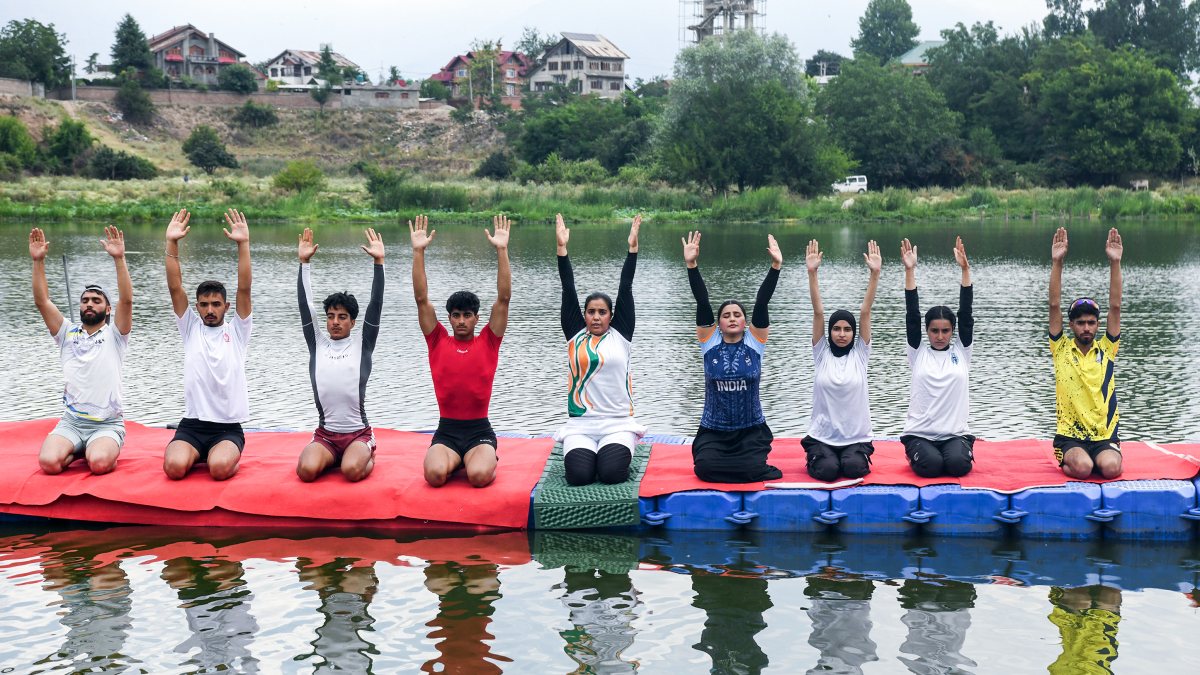 People practice floating yoga at Pokhribal Lake in Srinagar