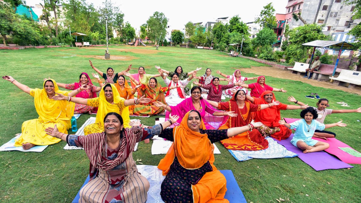 Women in Rajasthani attire practice yoga ahead of International Yoga Day
