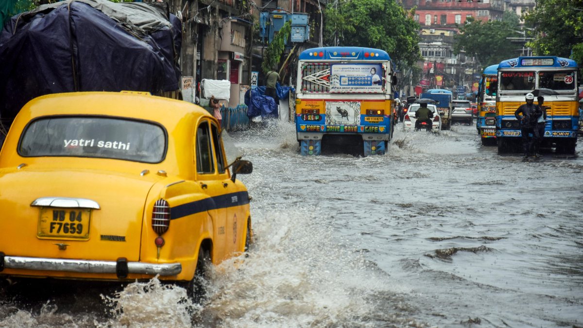 Kolkata commuters wade through waterlogged roads after heavy rain