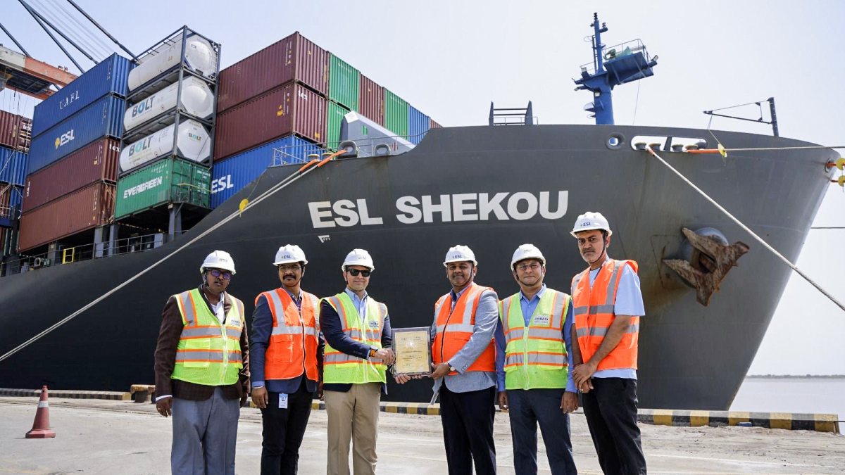 Officials pose for a photo in front of the ESL Shekou vessel following its…