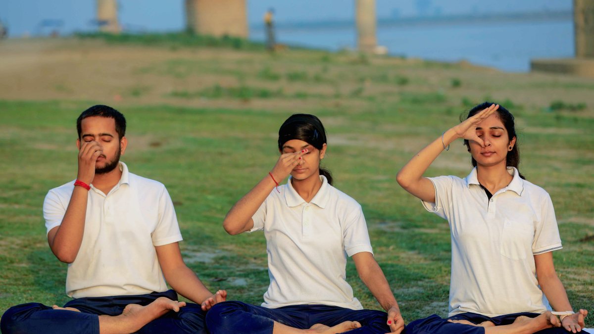 People practice yoga on the eve of International Yoga Day 2026 in Prayagraj