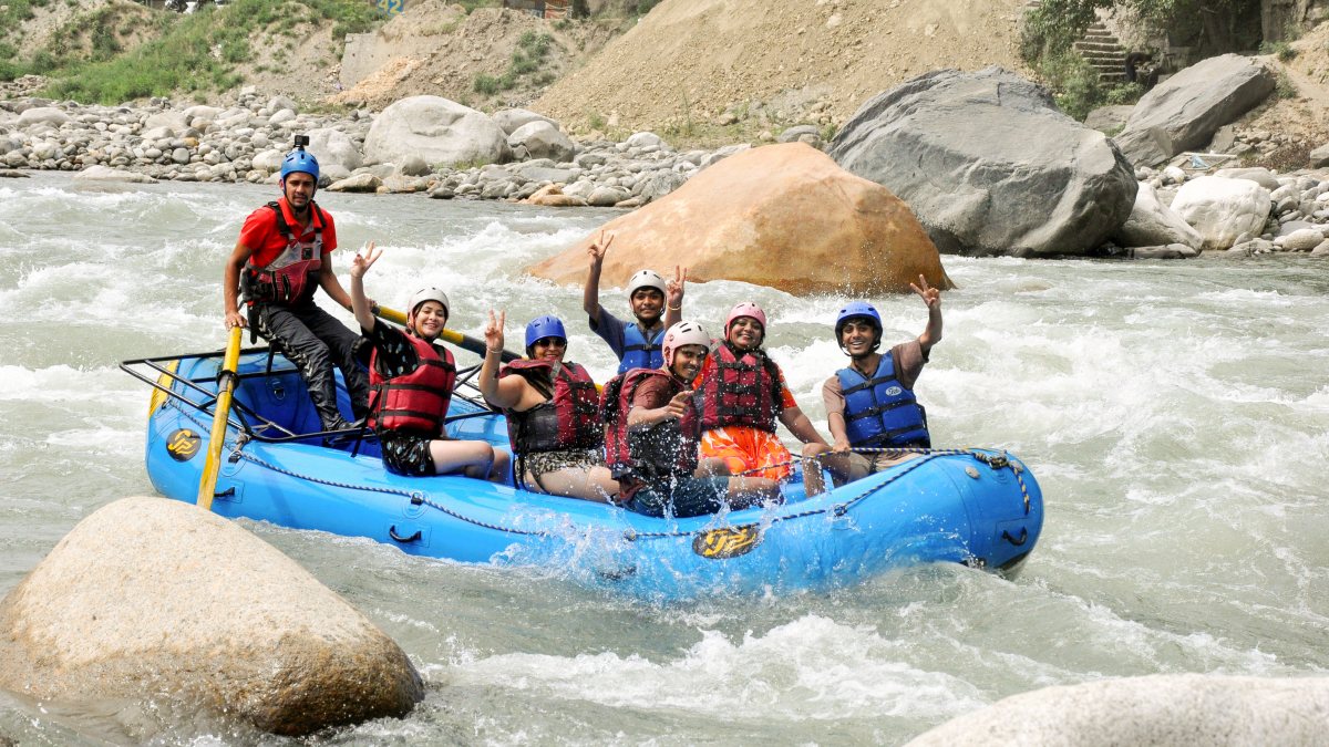 Tourists enjoy river rafting in Beas River at Manali
