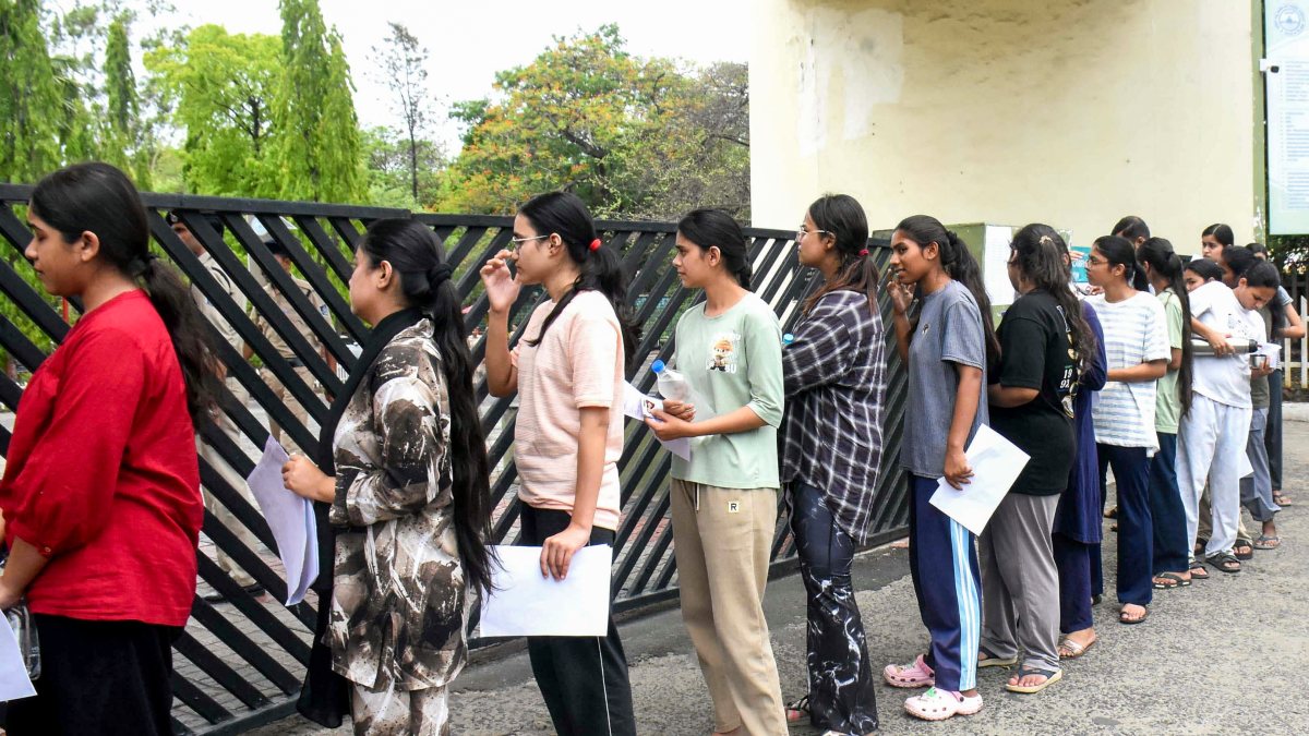 Students wait outside an exam centre before appearing for the NEET-UG-2026…