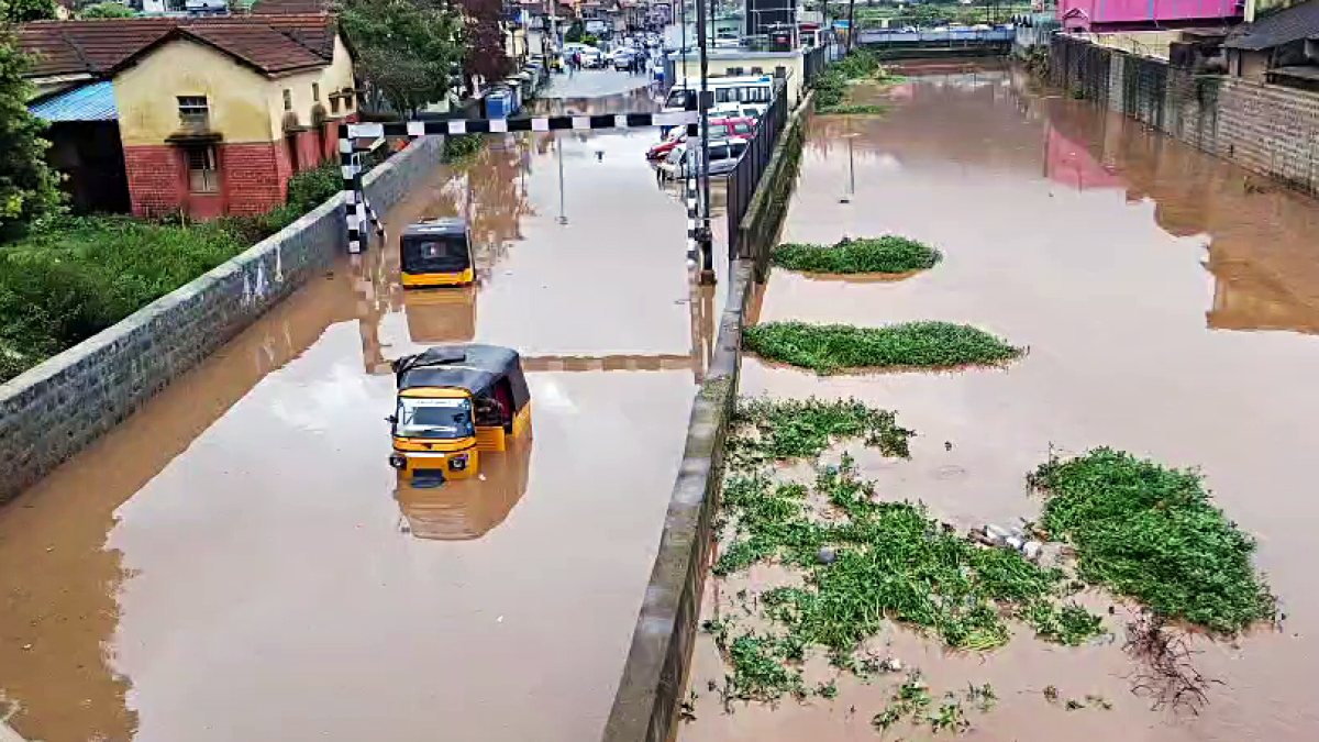 Autorickshaw wade through a waterlogged road following heavy rainfall near Ooty…