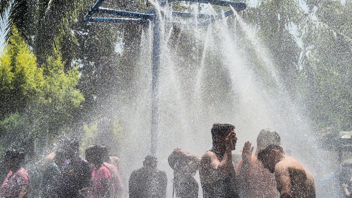 People enjoy the water park on a hot summer day, in Jalandhar on Monday.