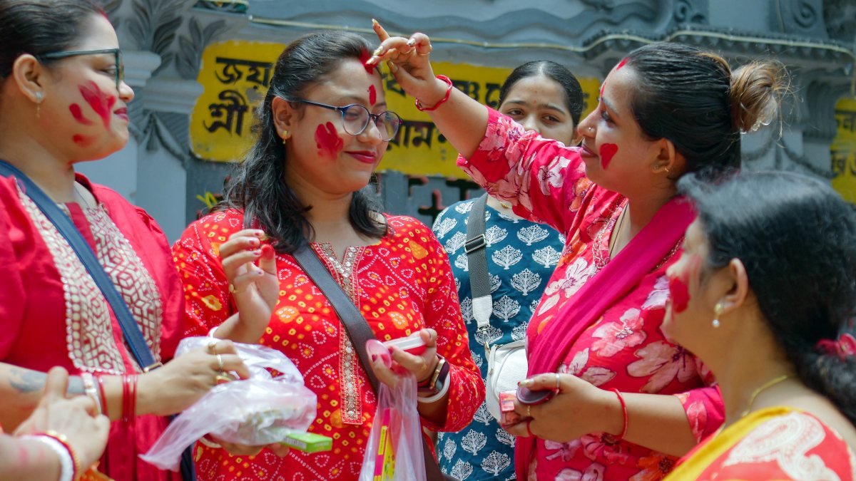 Married Hindu women apply vermilion to each other during the Ambubachi Mela…