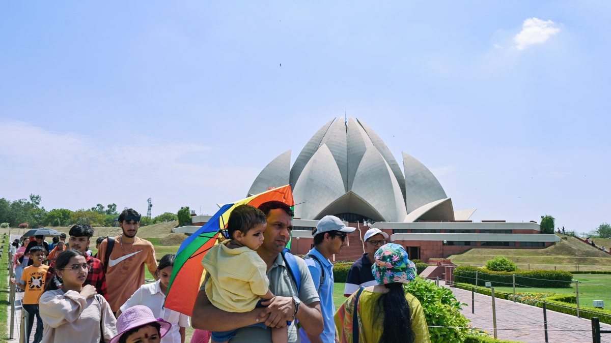 Family seeks shade from scorching heat at Lotus Temple