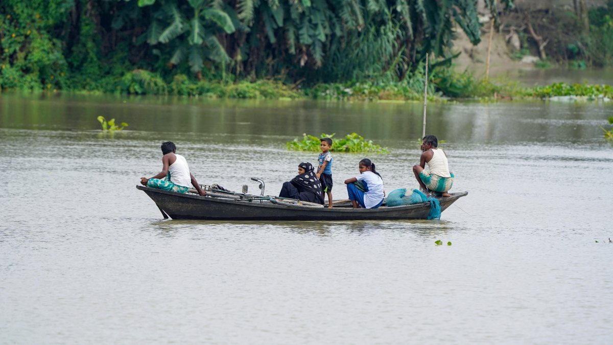 Boat commuters navigate flooded path in Assam's Morigaon
