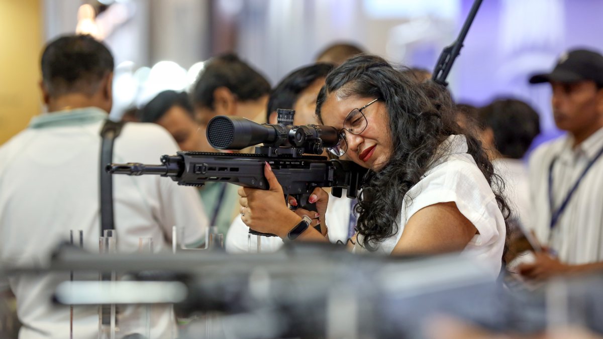Visitor aims gun at 11th International Police Expo 2026 in New Delhi
