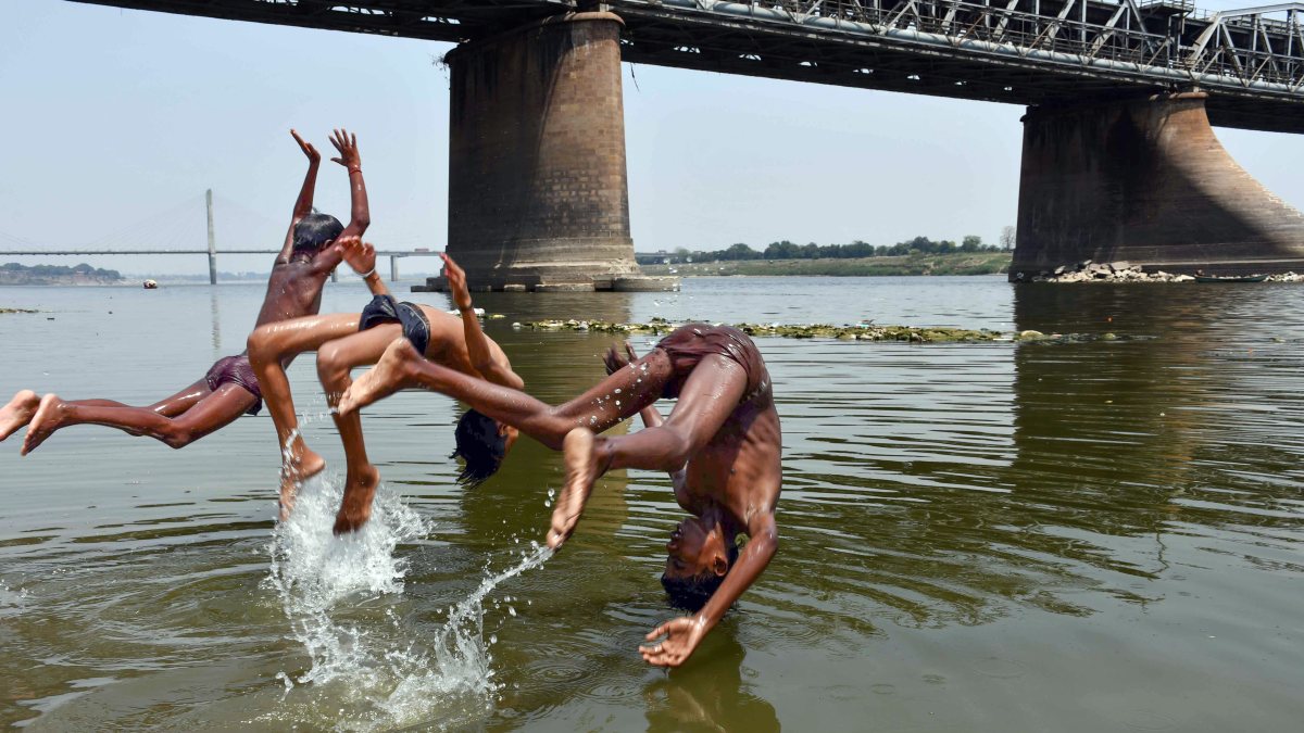 Children cool off in the Ganges as heatwave persists in Prayagraj