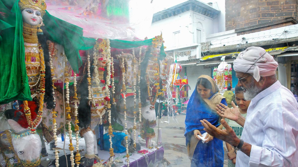 Hindu women worship Tazia on the occasion of Muharram, in Bhopal on Friday.