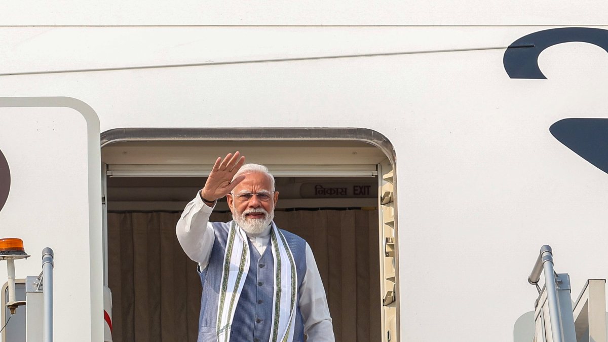 Prime Minister Narendra Modi waves as he emplanes for a three-day visit to…