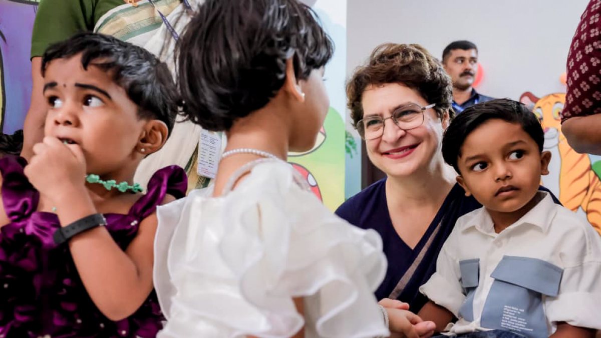 Priyanka Gandhi interacts with a child at Wayanad Anganwadi launch