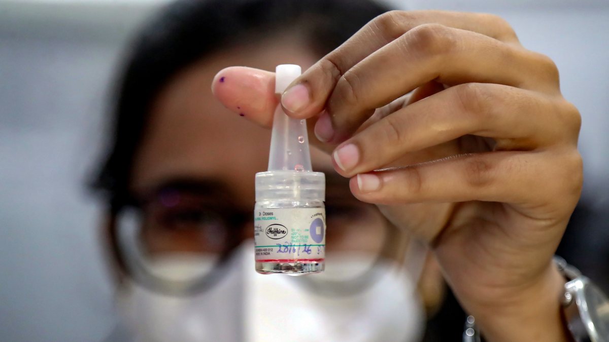 A health worker holds polio vaccine bottle during the 'Pulse Polio'…