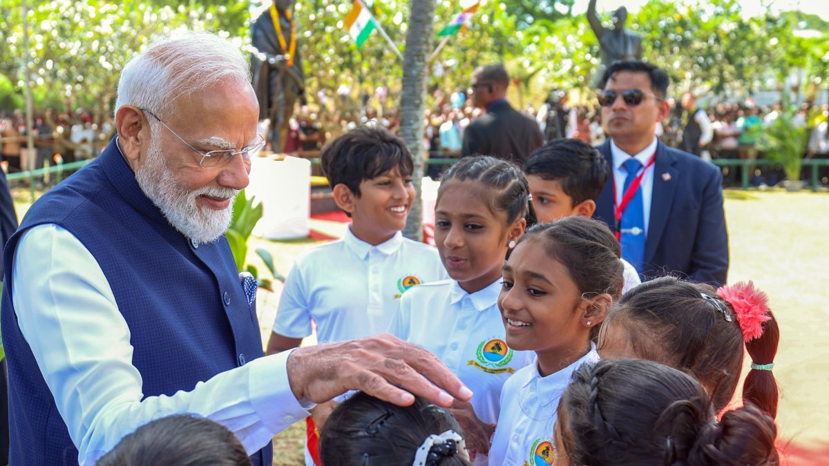 Modi interacts with children at Mahatma Gandhi statue in Victoria