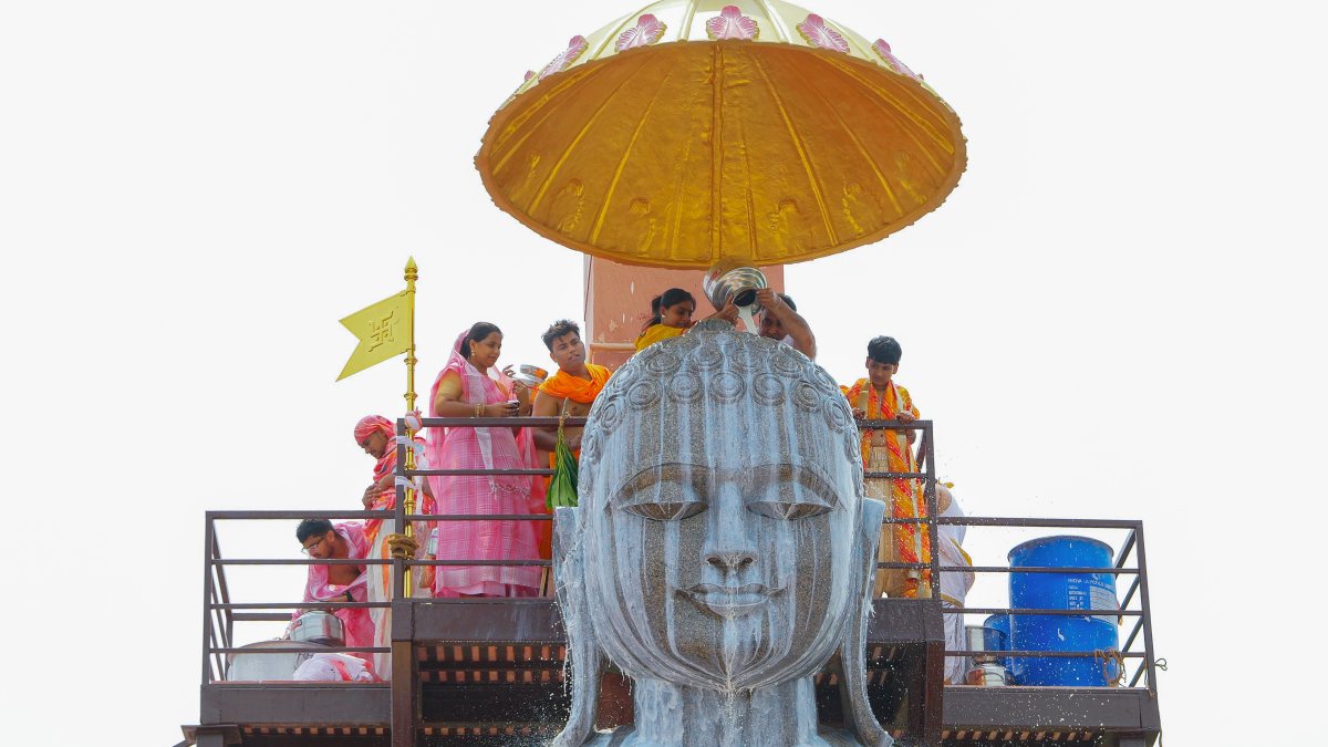 Devotees offer 'Abhishek' with milk to the 21-foot statue of Lord Adinath on…