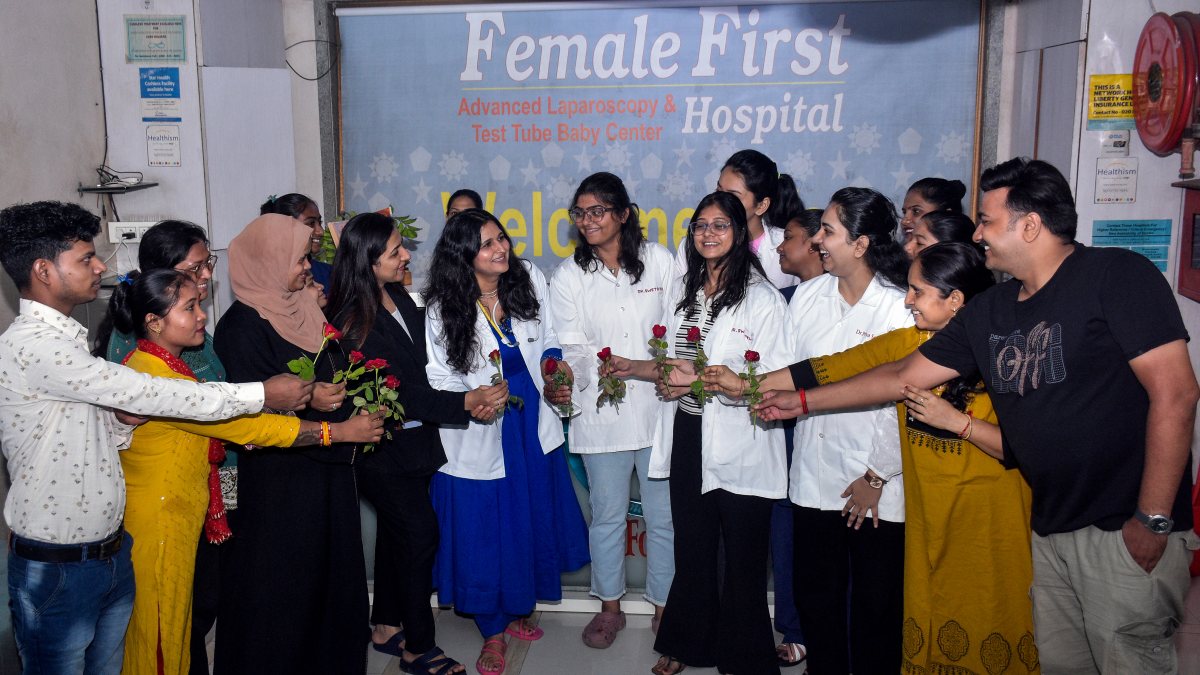 Staff offer flowers to a doctor as the Female First Hospital celebrates the…