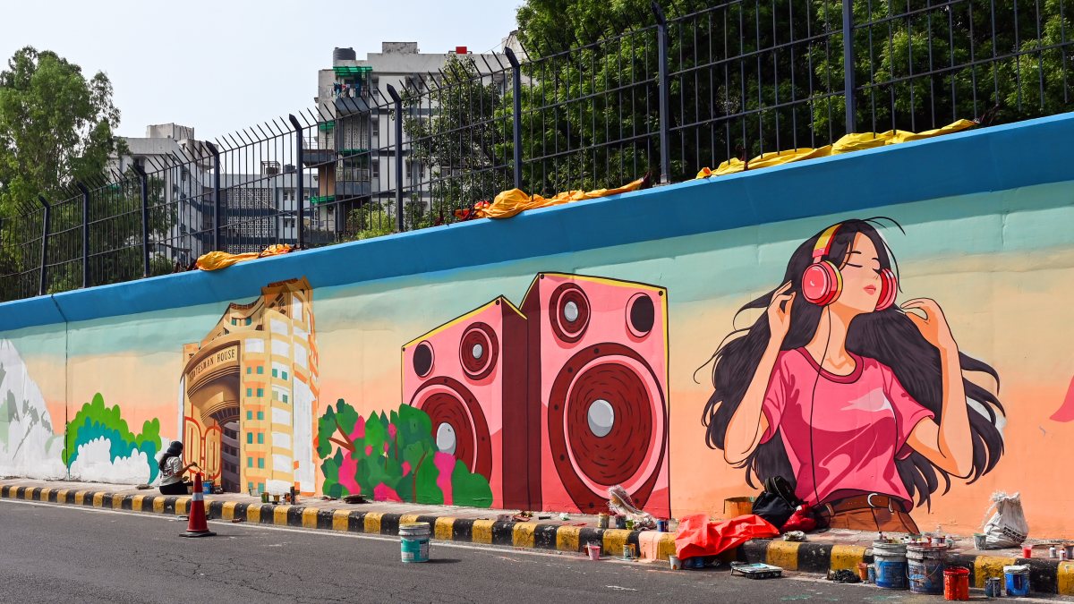 Artists paint a colorful mural in New Delhi public art initiative