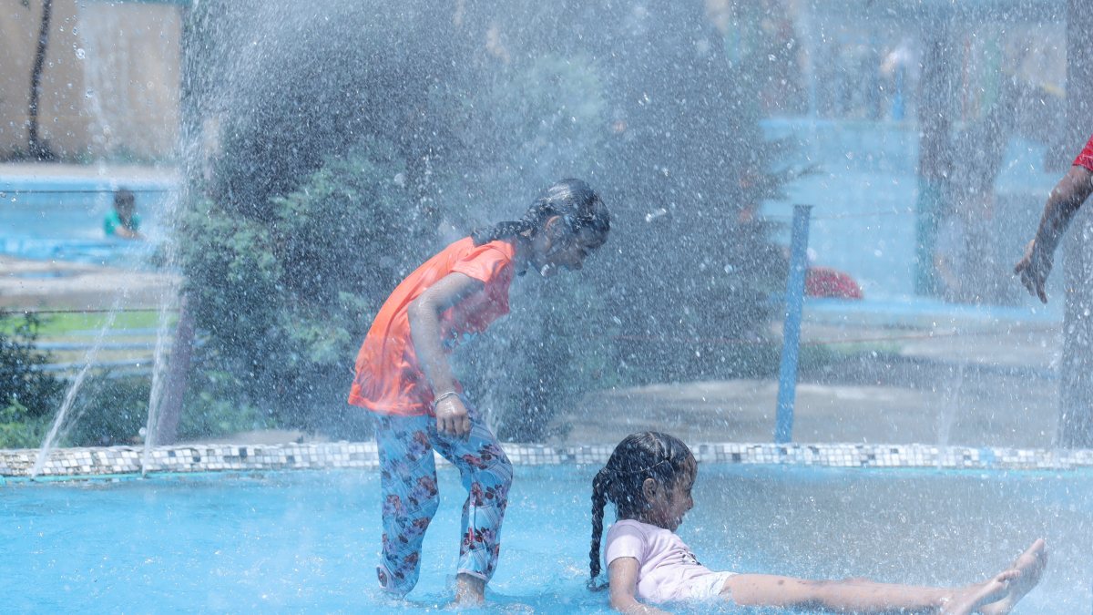 Children splash at water park to beat summer heat