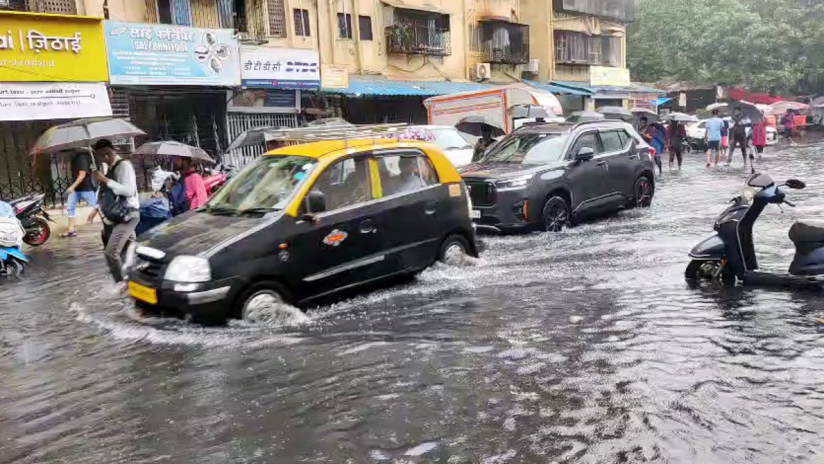 Mumbai commuters wade through waterlogged Prabhadevi road