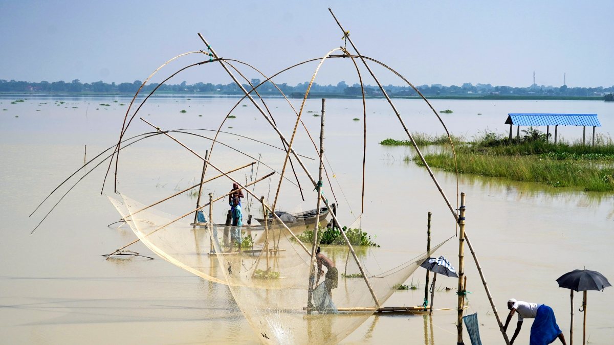 Fishermen cast nets in flood-hit Morigaon