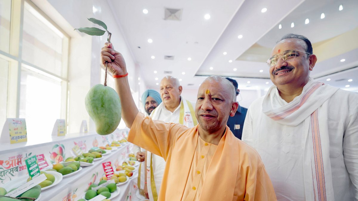 Yogi Adityanath holds mango at UP Mango Festival 2026