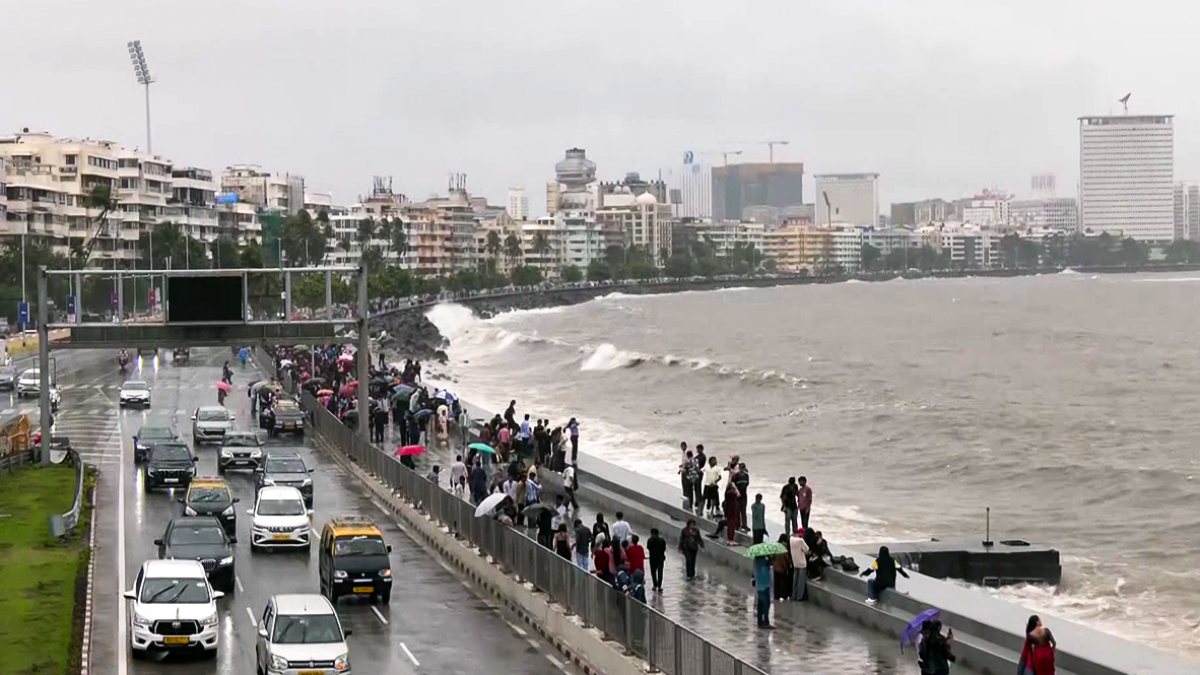 People enjoy crashing waves at Marine Drive during high tide