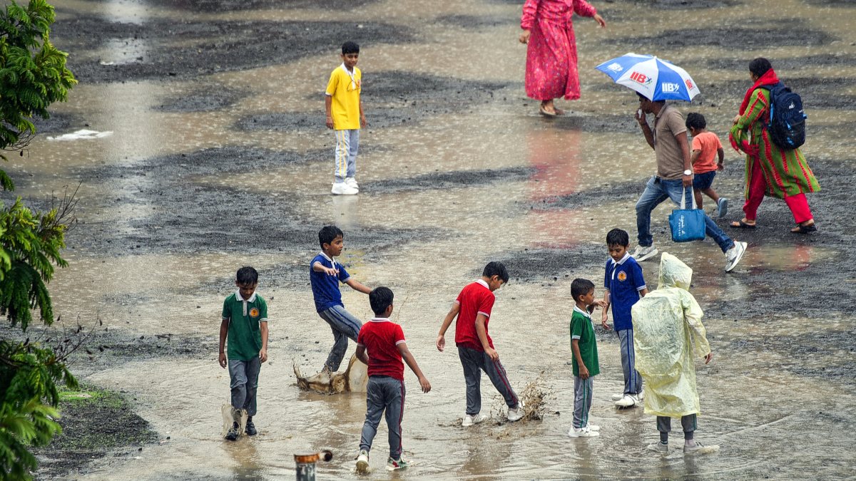 School students enjoy after school ends amid rainfall in Akola