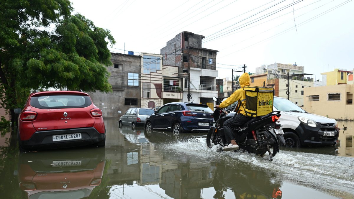 Delivery boy navigates waterlogged Raipur street after heavy rain