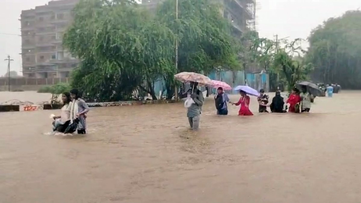 Mumbai residents wade through waterlogged streets after heavy rain